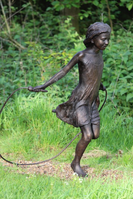 child skipping sculpture